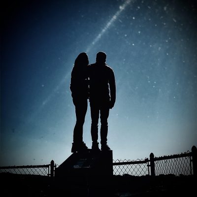 Silhouetted couple with backdrop of night sky